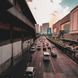 Vehicles on road amidst buildings in city