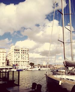 View of harbor against cloudy sky