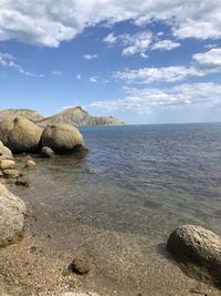 Rocks in sea against sky