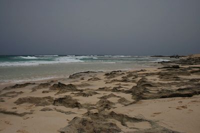 Scenic view of beach against clear sky