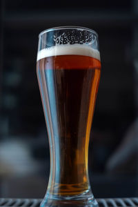 Close-up of beer glass on table