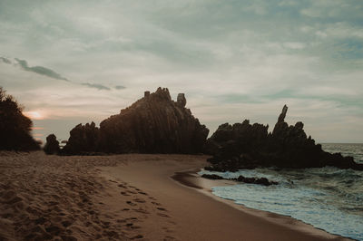 Scenic view of beach against sky during sunset