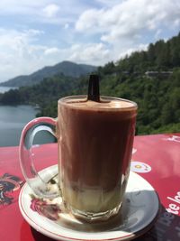 Close-up of coffee on table against sky