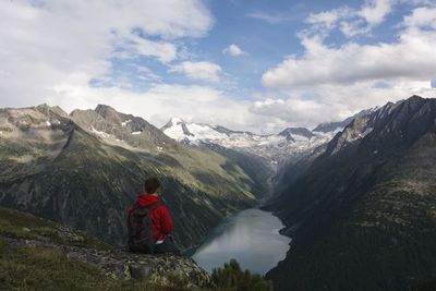 Man looking at mountains against sky