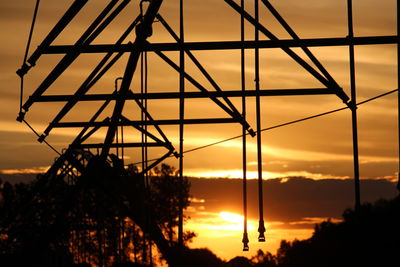 Low angle view of silhouette metal structure against sky