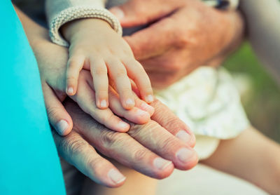 Close-up of people stacking hands