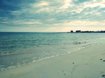 Scenic view of beach against sky during sunset