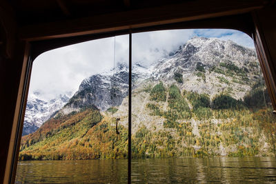 Scenic view of lake königssee in fall with mountains against sky