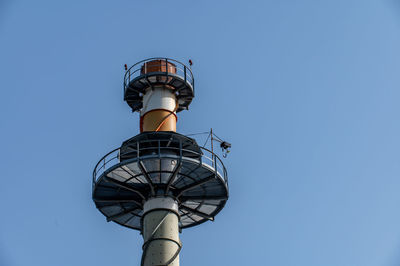 Low angle view of lighthouse against clear blue sky