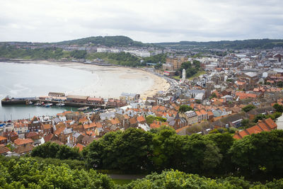 High angle view of townscape by sea against sky of scarborough bay and old town