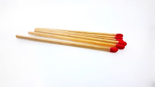 Close-up of colored pencils over white background