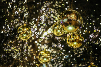 Low angle view of christmas ornament hanging against defocused lights