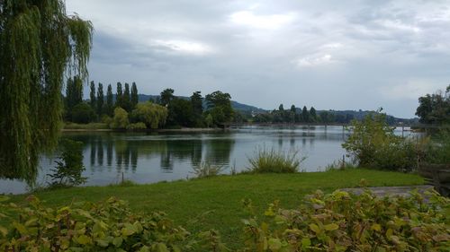 Scenic view of lake against cloudy sky