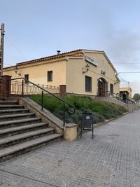 Footpath by building against sky