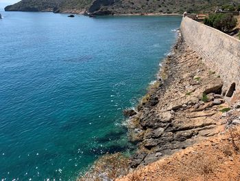 High angle view of rocks on sea shore