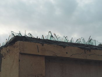 Low angle view of house roof against sky