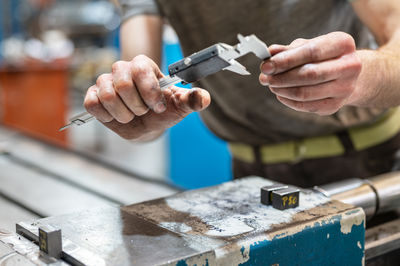 Cropped hand of man repairing car