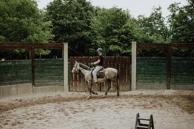 Young man riding horse