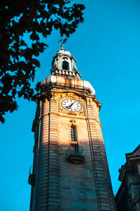 Low angle view of clock tower against building