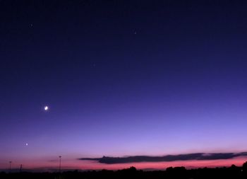 Silhouette landscape against sky at night