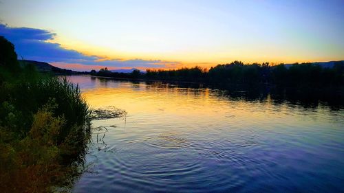 Scenic view of lake against sky during sunset