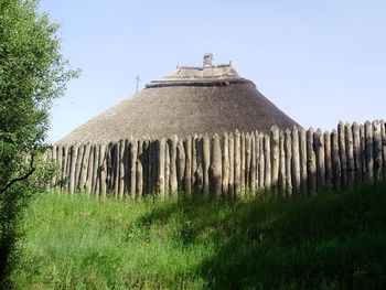 Built structure on landscape against clear sky