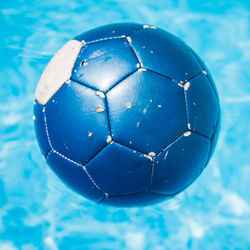 Close-up of soccer ball floating in swimming pool