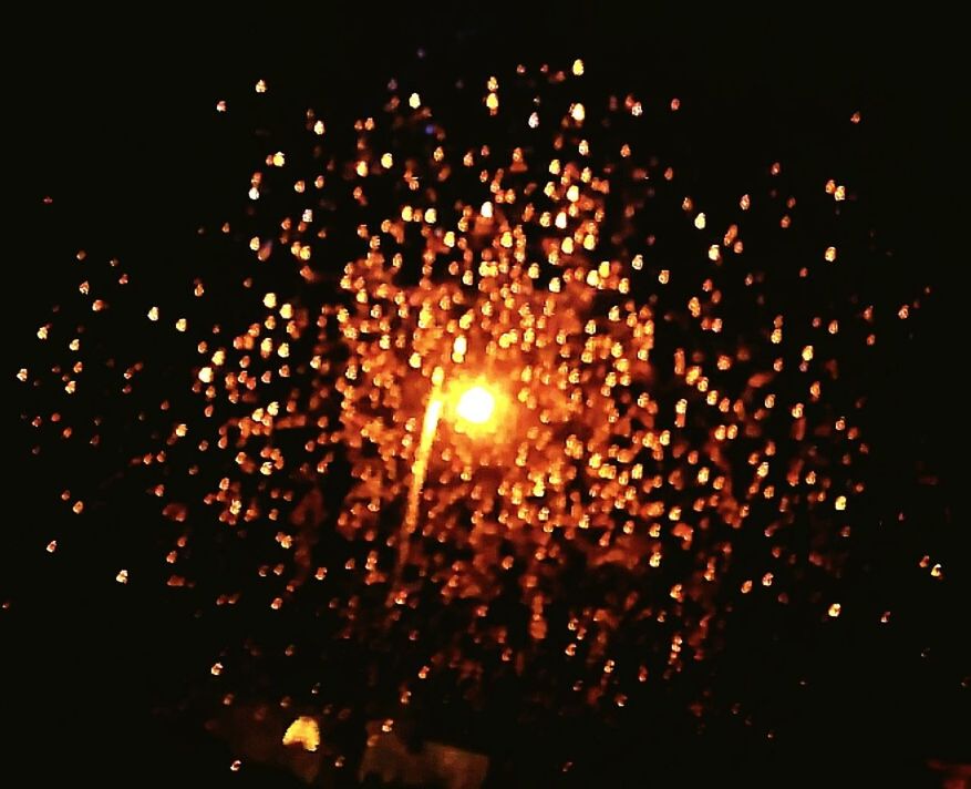 CLOSE-UP OF ILLUMINATED FIREWORKS AT NIGHT