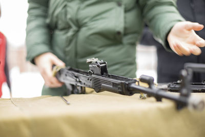 Children learn to shoot in russia. assembly of automatic weapons. lesson in military training. 