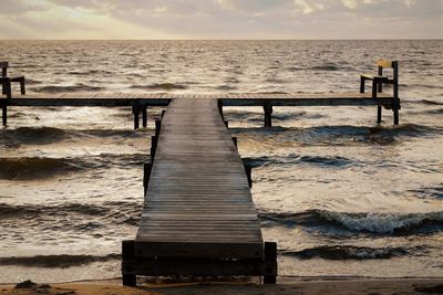 Wooden pier on sea against sky during sunset in denmark