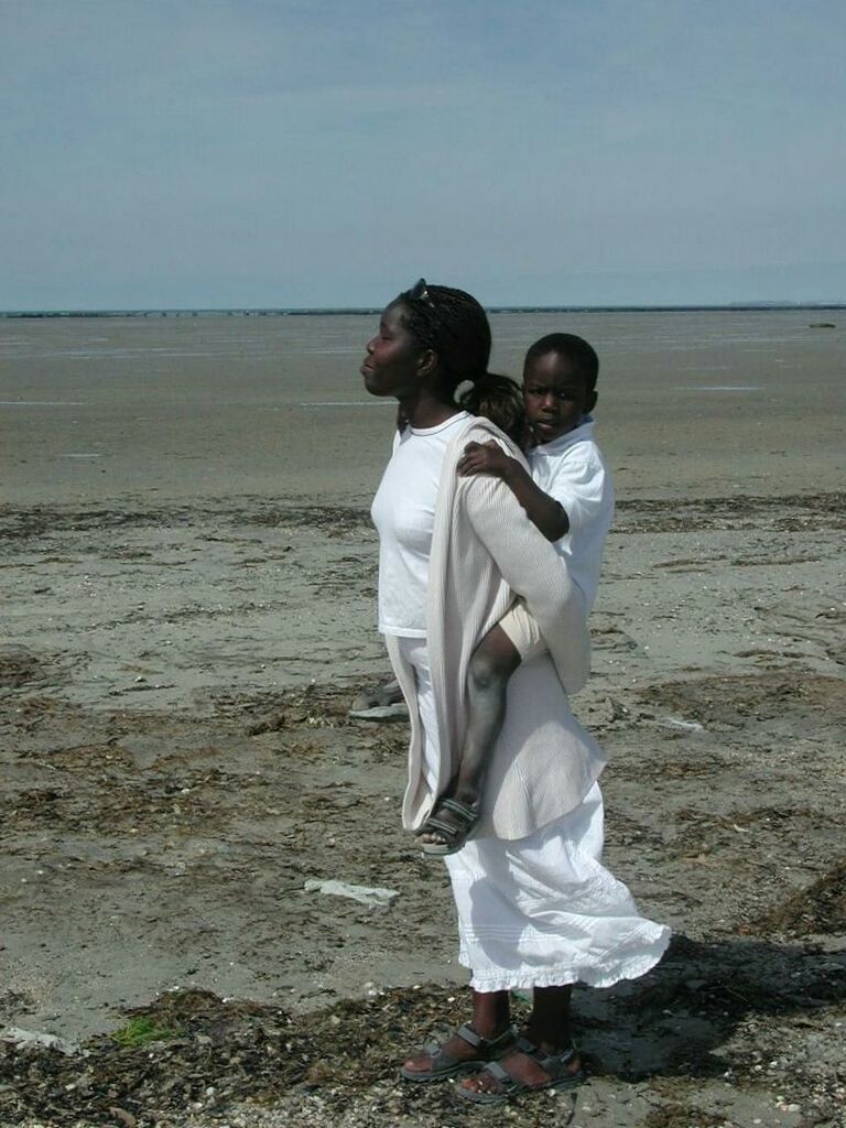 MAN WALKING ON BEACH