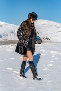 Full length of woman on snow covered land