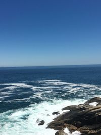 Scenic view of sea against clear blue sky