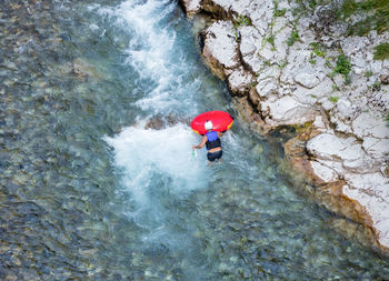 High angle view of man with inflatable in river