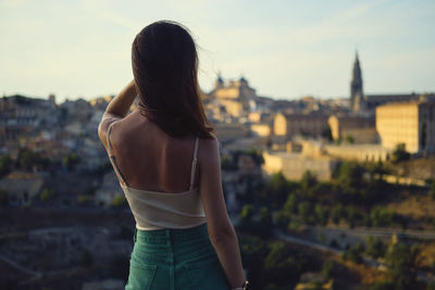 Rear view of woman looking at cityscape