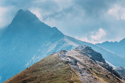 Scenic view of mountains against cloudy sky