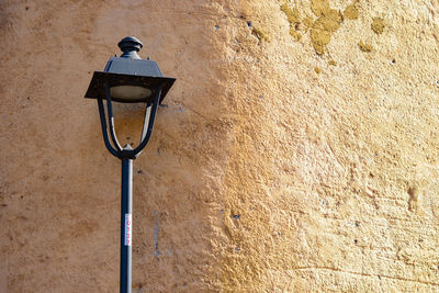 Low angle view of street light on wall