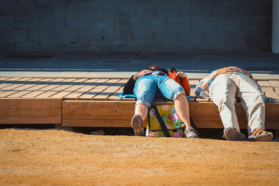 Rear view of friends sitting outdoors