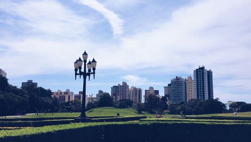 View of cityscape against cloudy sky