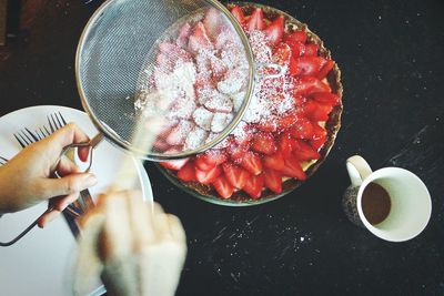 Cropped image of hand holding food