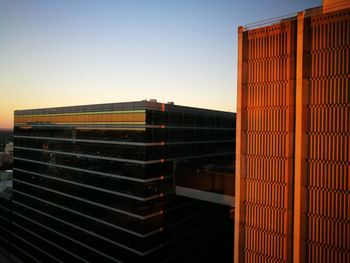 Modern building against clear sky during sunset