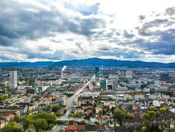 High angle view of cityscape against cloudy sky