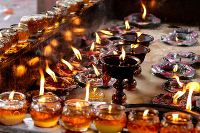 Lit tea light candles in temple