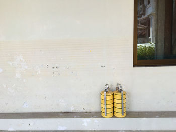 Yellow lunch boxes against wall