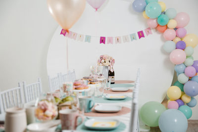 Multi colored balloons on table at home