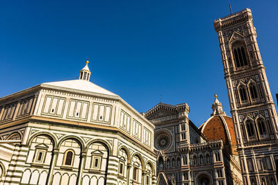 Low angle view of duomo santa maria del fiore against clear blue sky in city