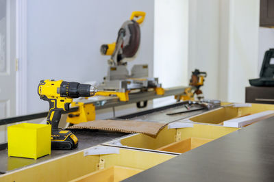 Close-up of yellow machine on table