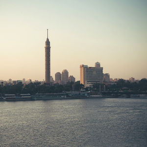 City at waterfront during sunset