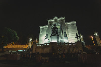 Low angle view of illuminated building against sky at night