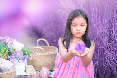 Portrait of a girl holding pink flower